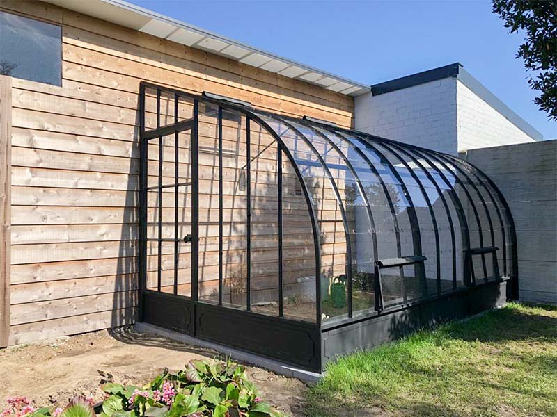 Creating a Cozy Oasis: Exploring the Benefits of a Corner Greenhouse for Your Garden
